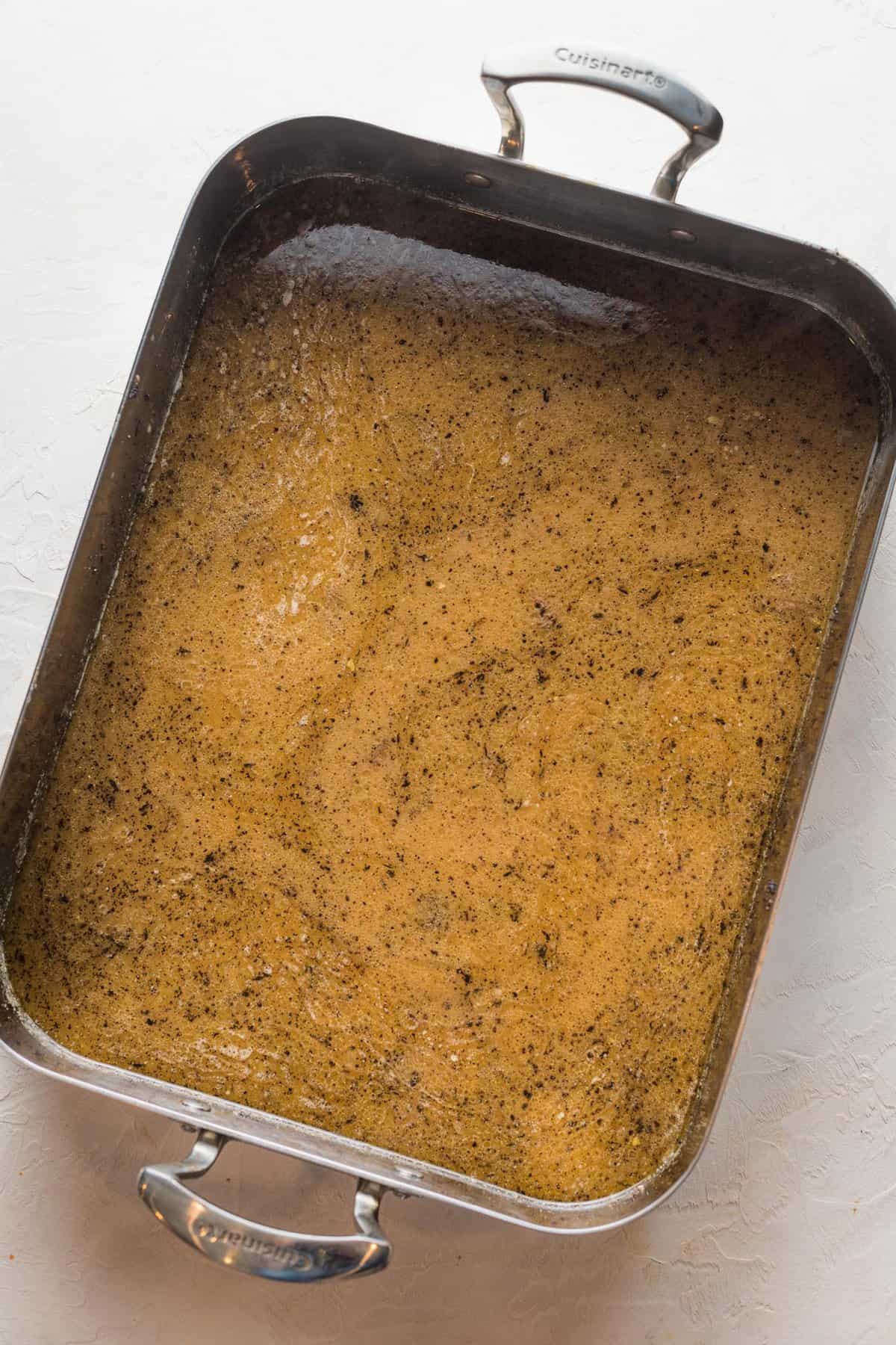 pan drippings in a large baking dish