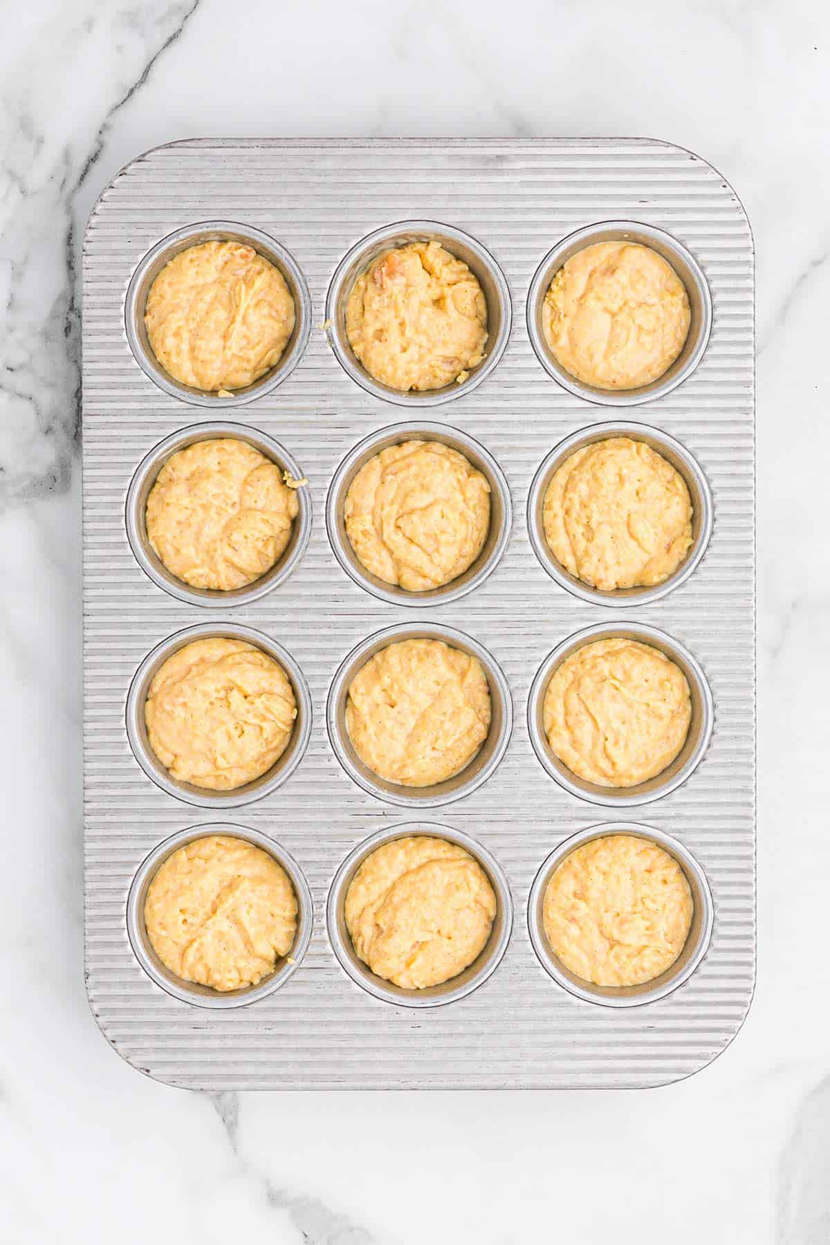 Batter poured into a muffin pan to bake.