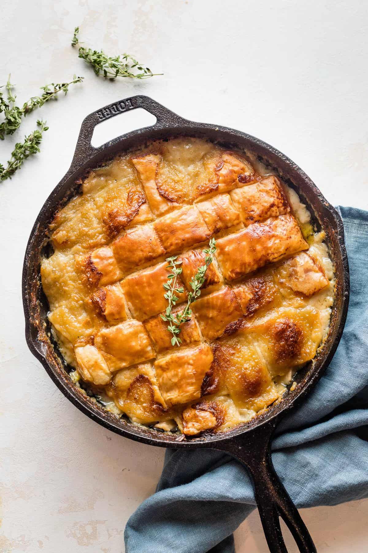 Baked turkey pot pie in a cast iron skillet.