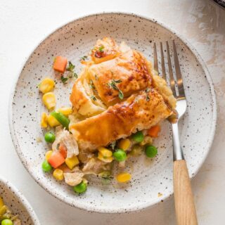 A slice of homemade turkey pot pie on a small plate.