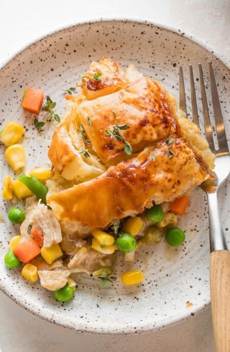 A slice of homemade turkey pot pie on a small plate.