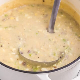 A ladle in a stockpot of homemade turkey giblet gravy.