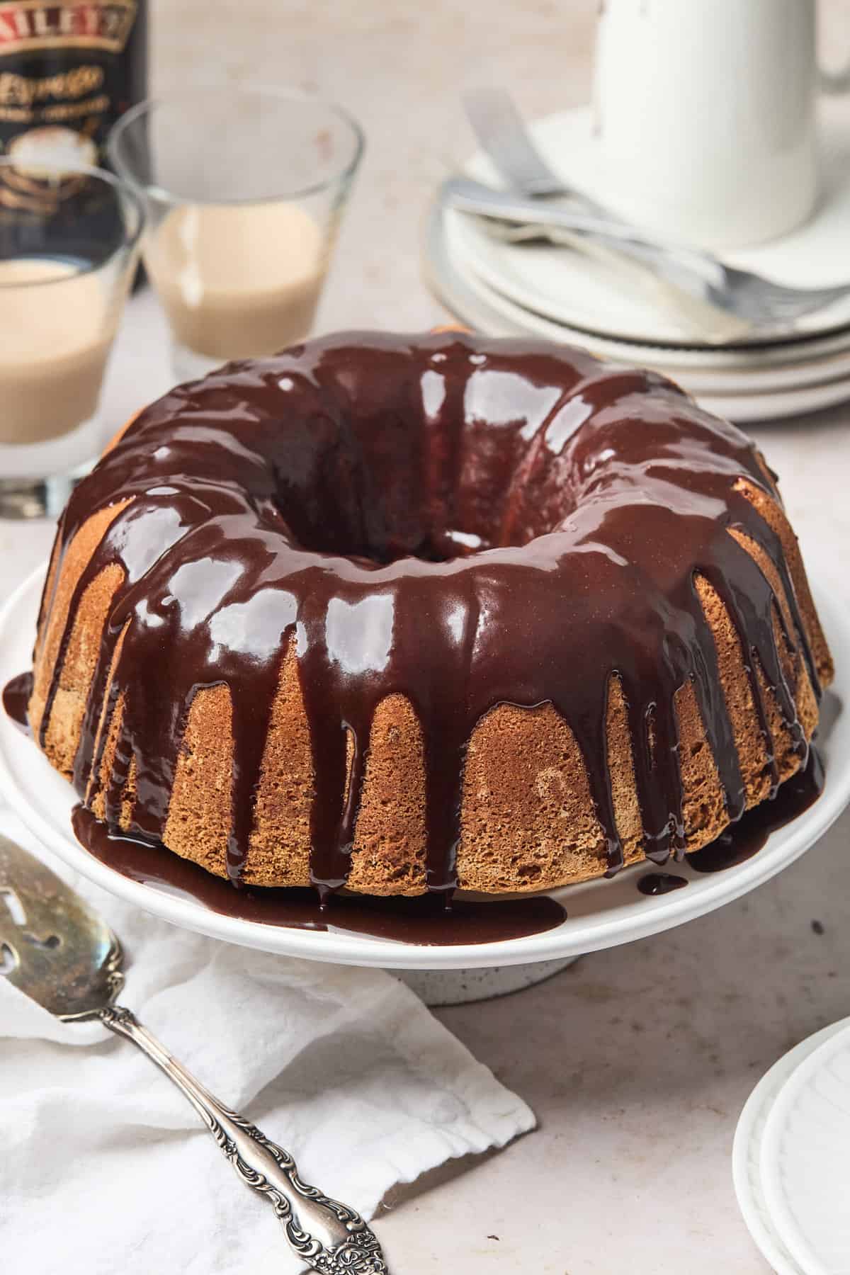 finished pound cake on a platter topped with chocolate ganache 