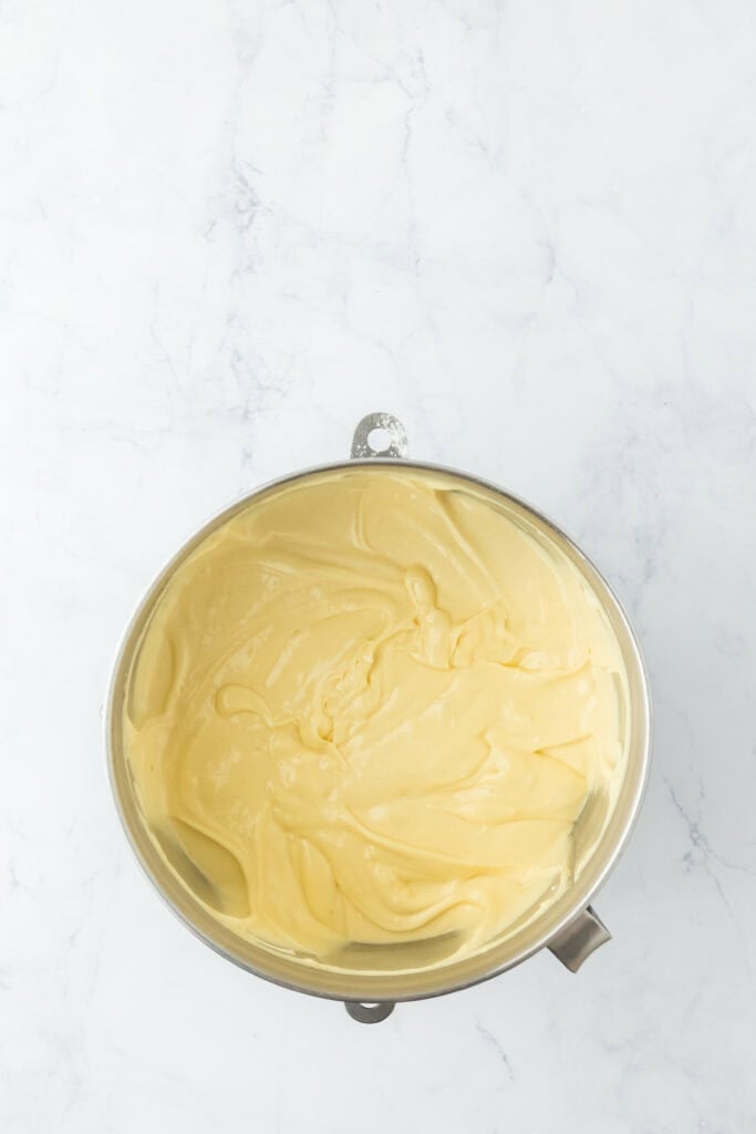 A silky yellow butter cake batter in a stand mixer bowl
