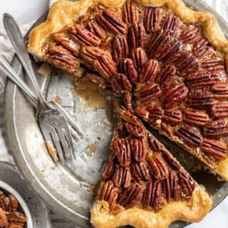 A cut into easy pecan pie recipe with forks on it before serving up