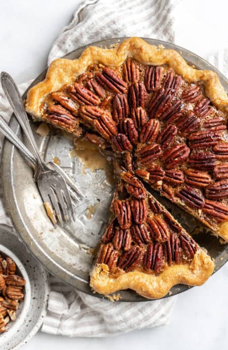 A cut into easy pecan pie recipe with forks on it before serving up