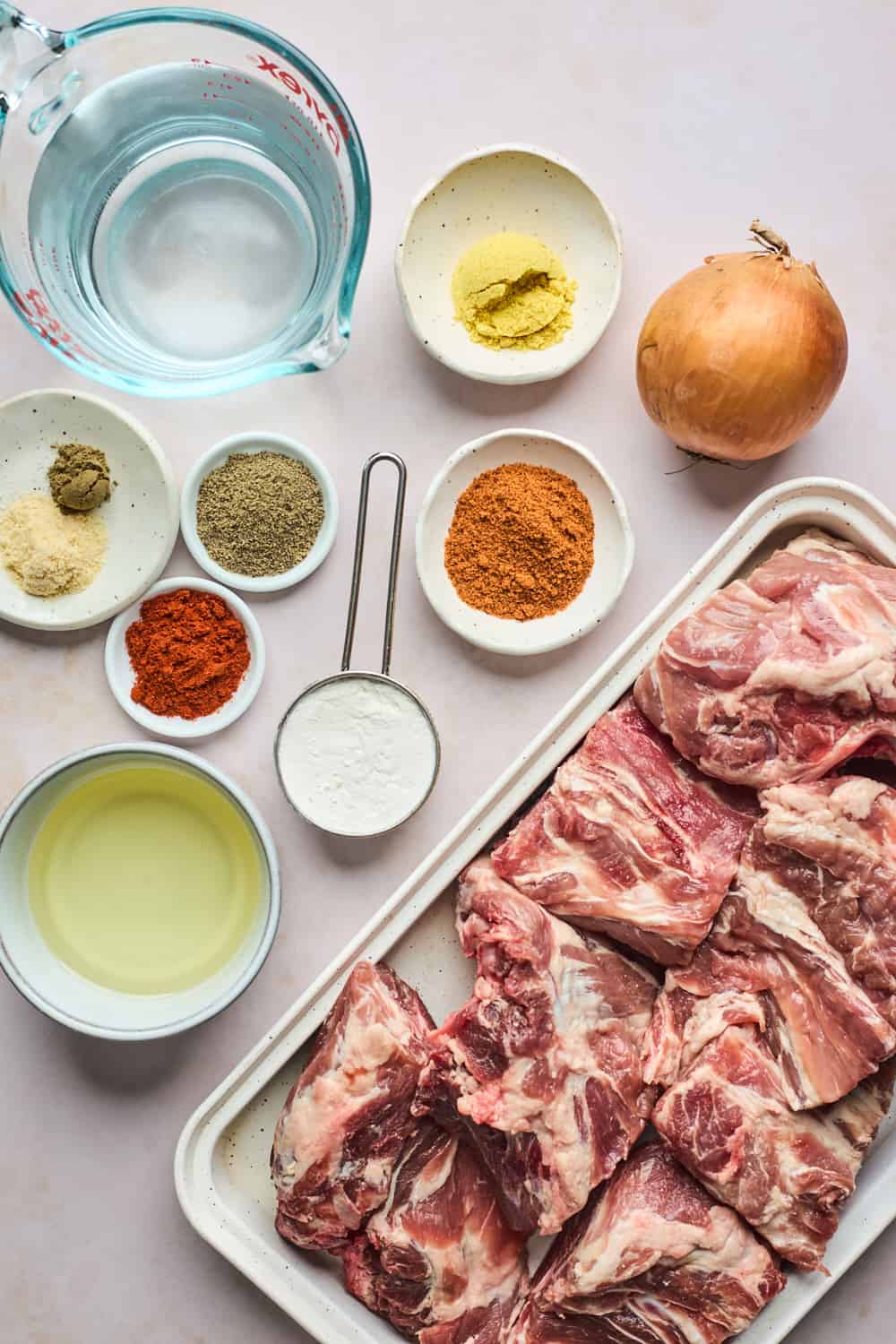 Ingredients to make roasted pork necks in small bowls on the counter.