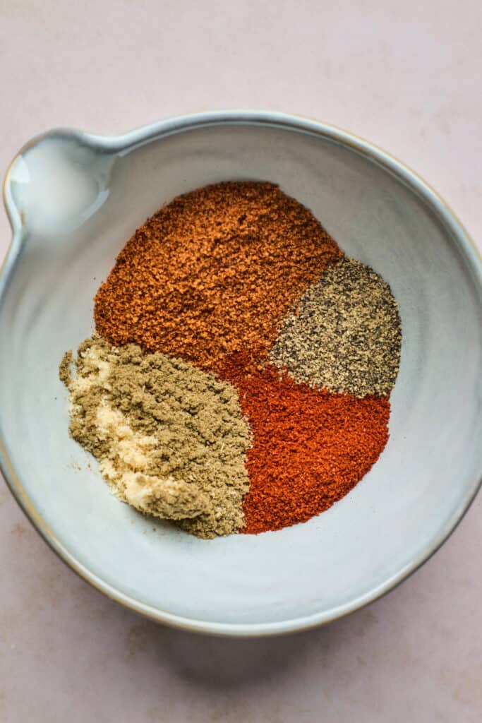 A small bowl of various seasonings and spices.