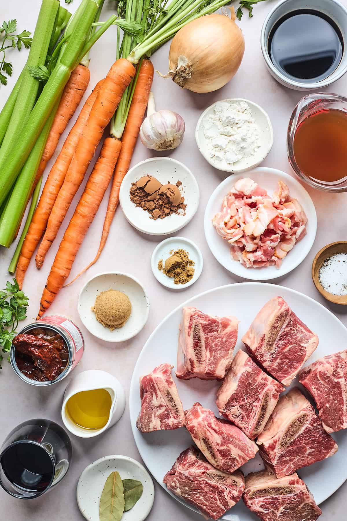 Ingredients to make beef short ribs laid out on a counter in small bowls.