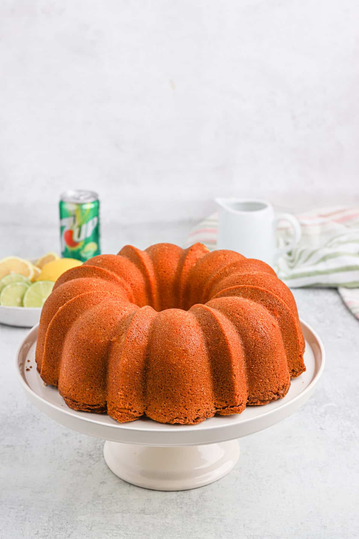 Plain 7-up pound cake on a white cake stand