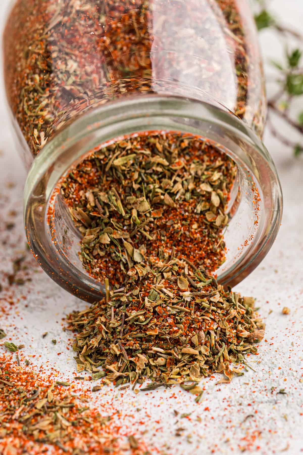 An open jar of blackened seasoning recipe set on its side.