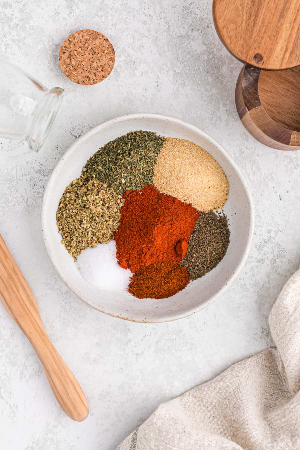 Individual spices set in mounds in a flat bowl.