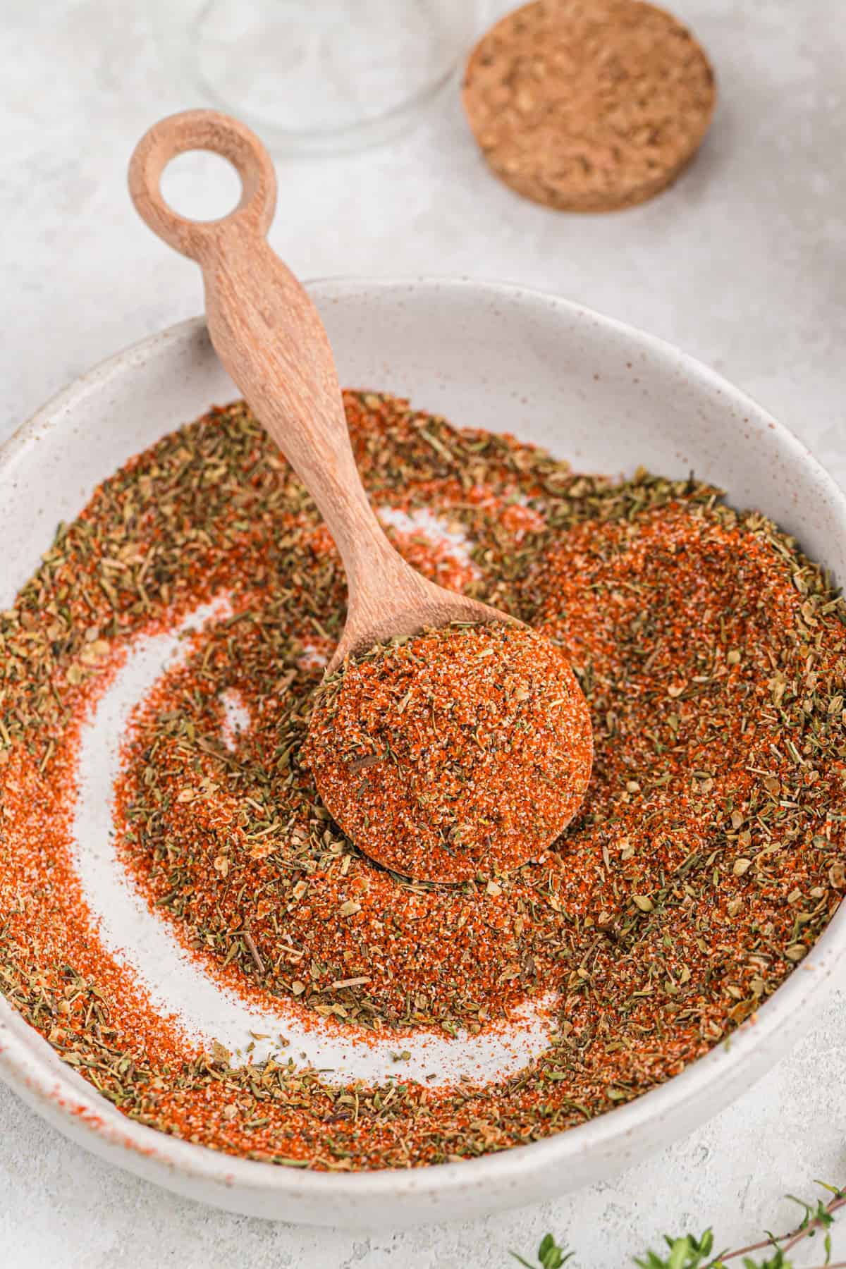 Blackened seasoning on a small plate with a wooden tablespoon.