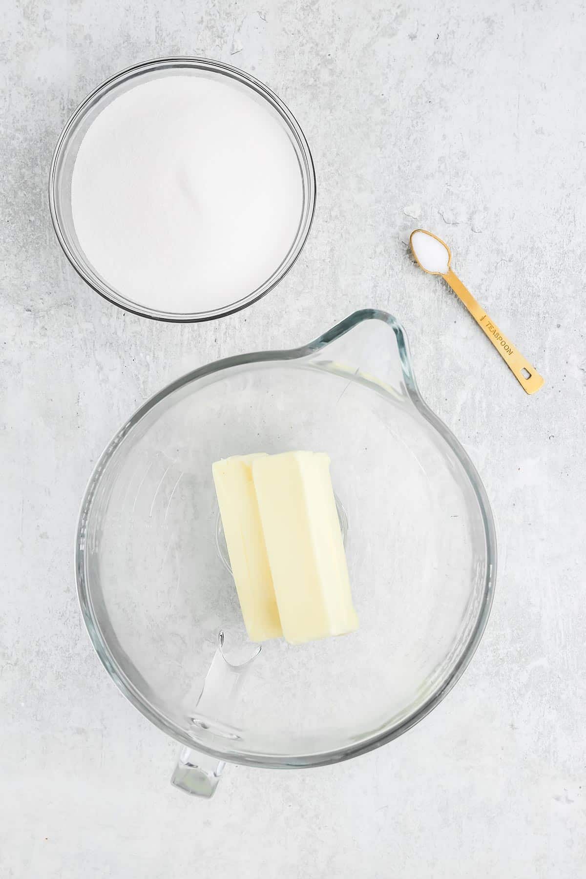 Butter in a mixing bowl on white countertop