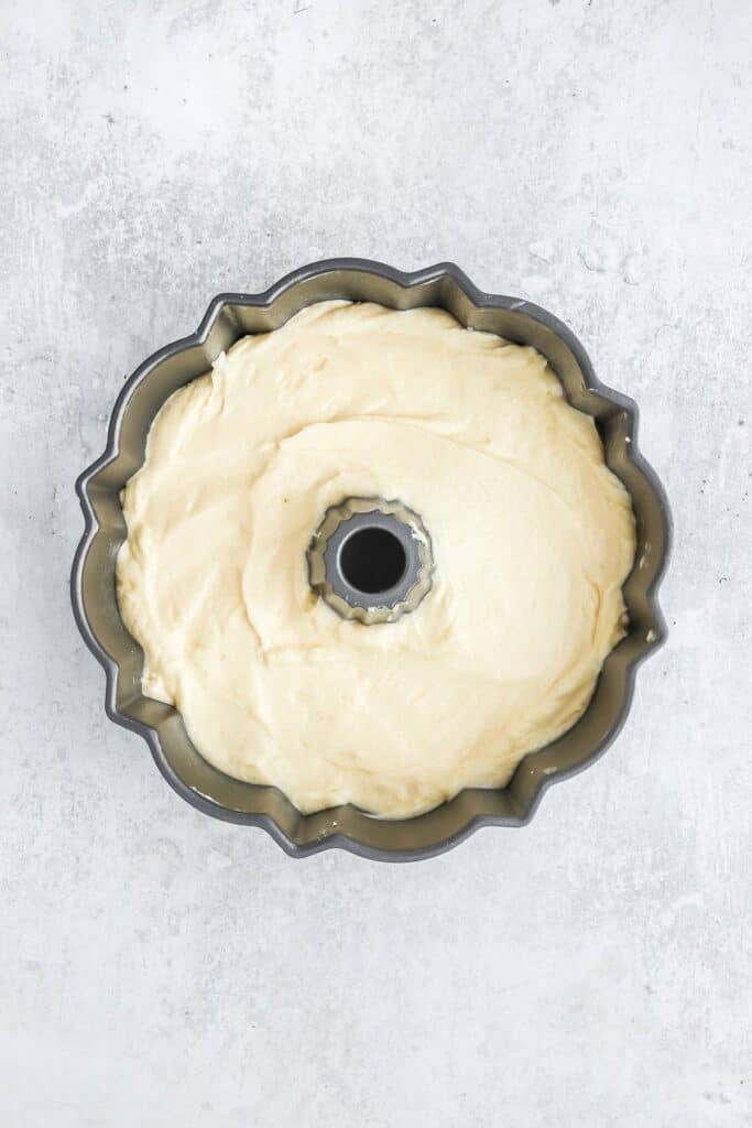 7-up pound cake recipe batter poured into bundt pan on a white background.