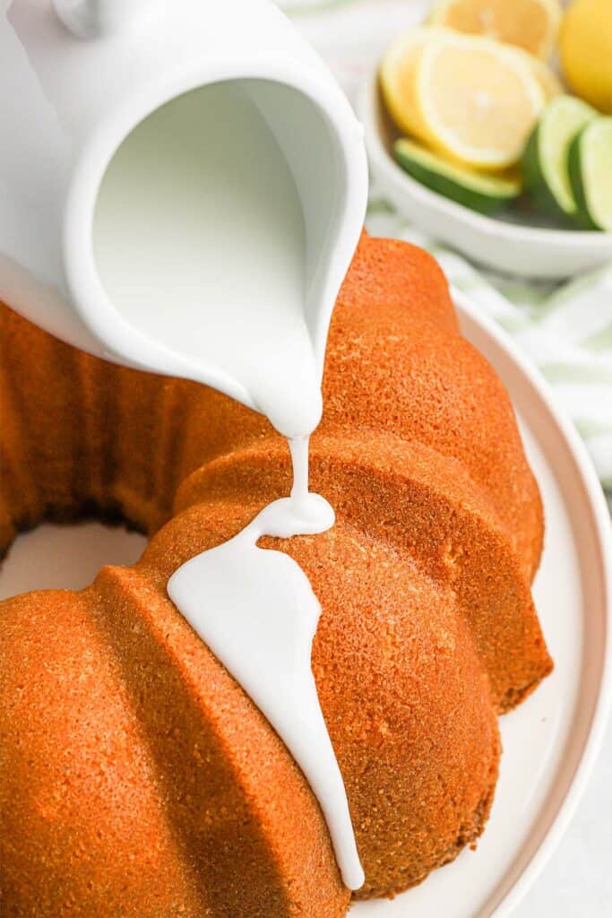 Pouring the icing over the baked 7up pound cake.