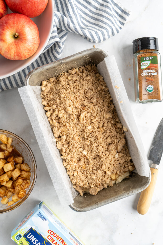 Crumble sprinkled over loaf cake batter