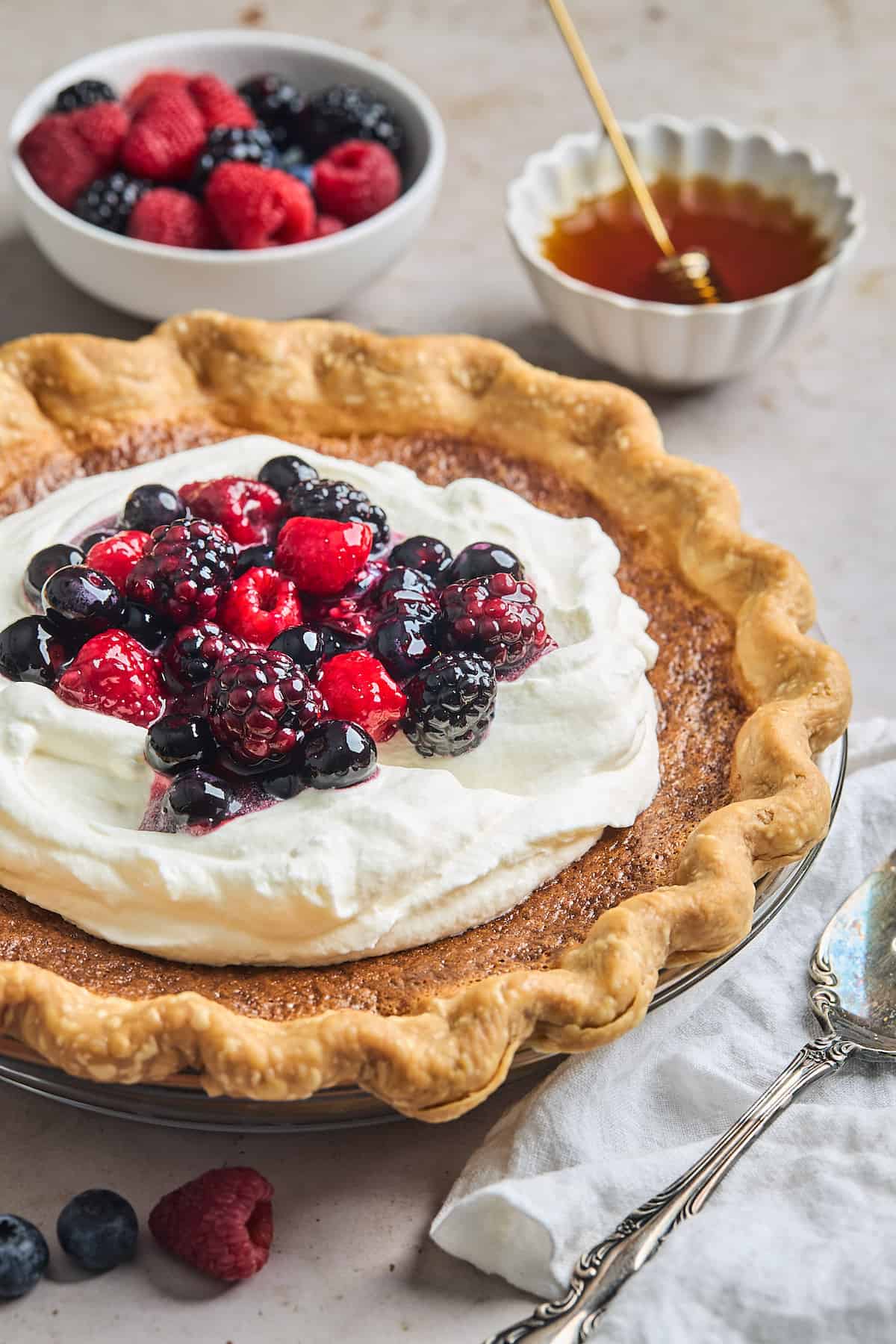 Honey pie topped with fresh whipped cream and berries.