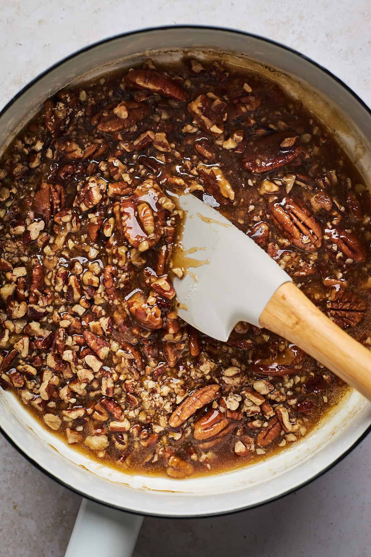 pecans added to a small pan for the topping