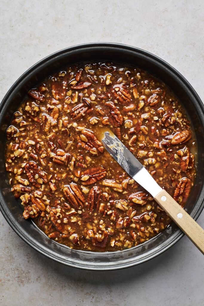 Pecan pie topping in a cake pan spread out