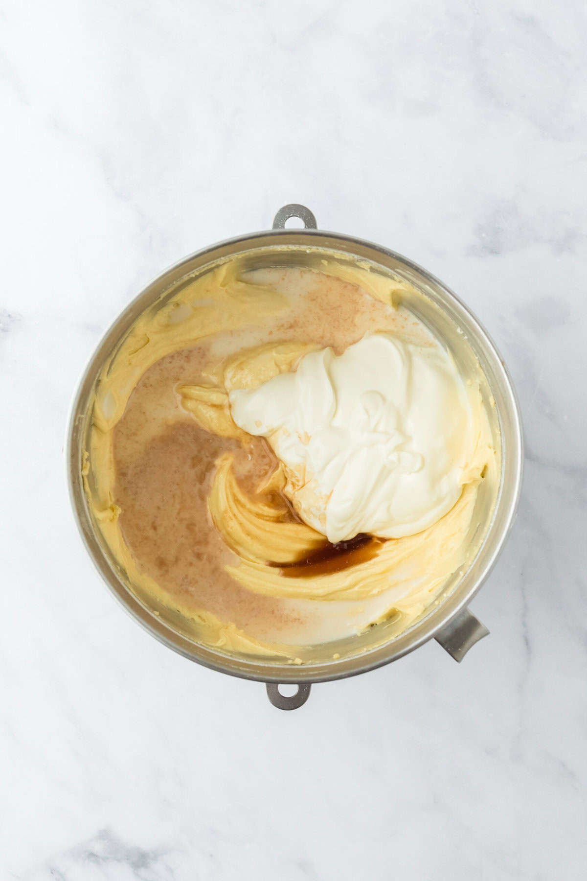 Sour cream, milk and vanilla added to stand mixer to mix pound cake batter