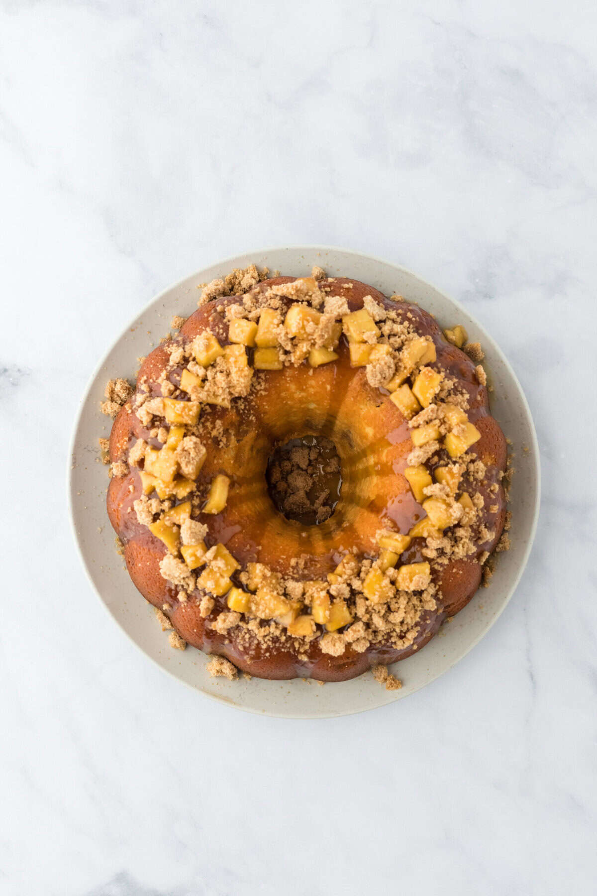 Garnished caramel apple cake on a white countertop