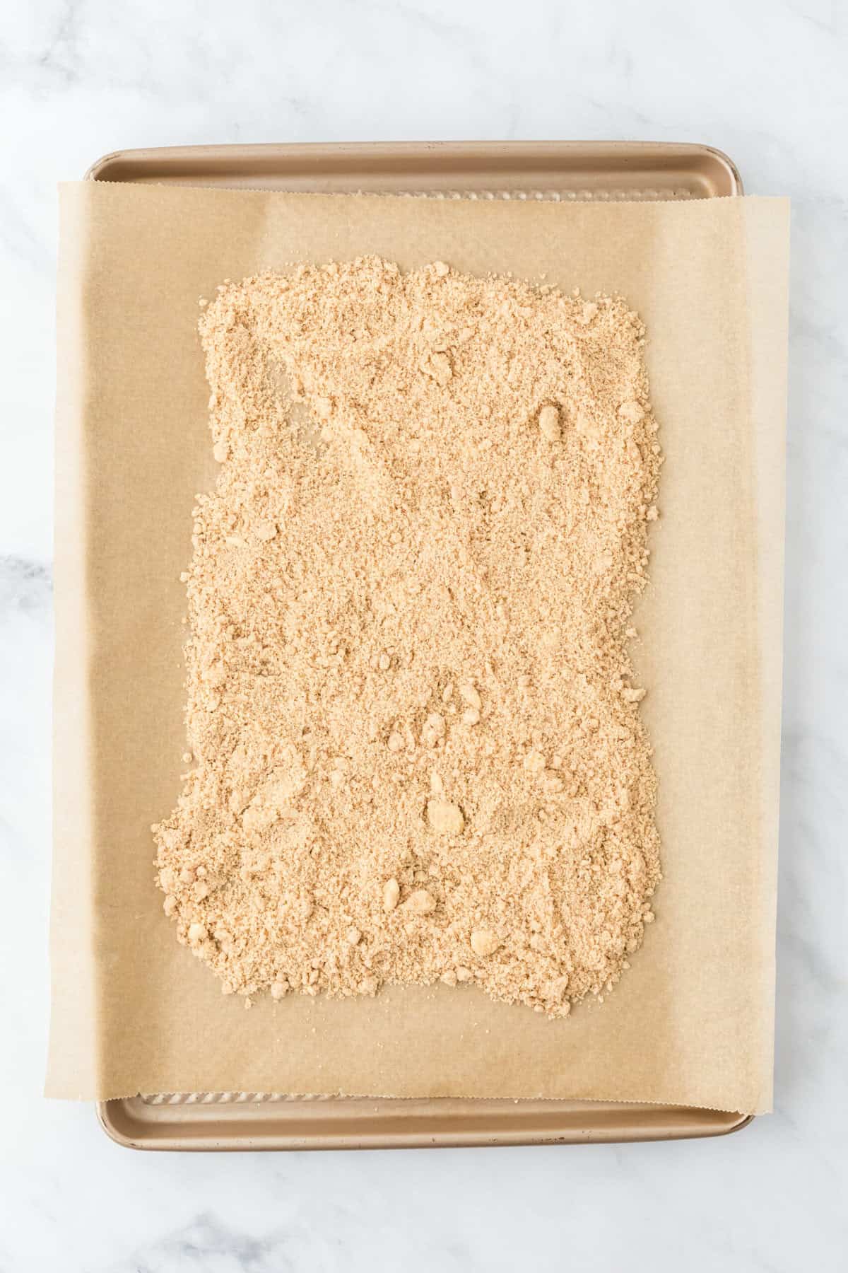 Streusel on parchment paper before adding to an oven