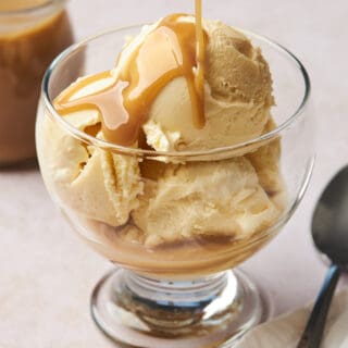 coconut caramel being drizzled overtop a bowl of ice cream