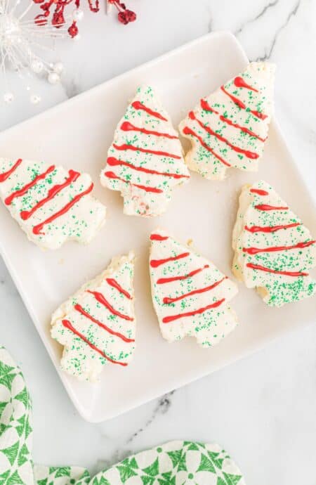 Overhead view of 6 little debbie christmas tree cakes on a white platter