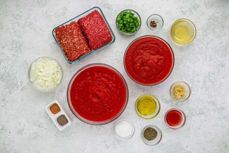 Ingredients to make homemade spaghetti sauce for spaghetti casserole recipe on gray background