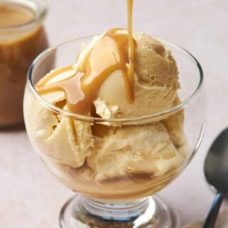 coconut caramel being drizzled overtop a bowl of ice cream