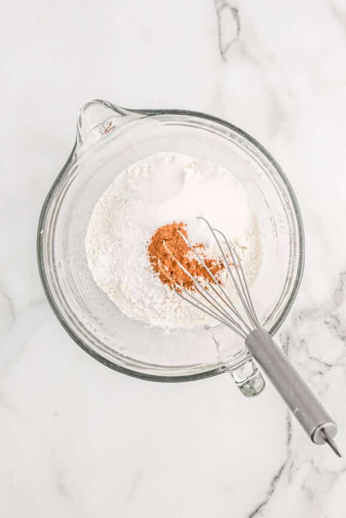 dry ingredients being whisked in a stand mixer bowl