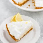A slice of lemon meringue icebox pie on a white plate.
