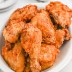 Buttermilk fried chicken on a white platter ready to enjoy