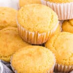 A close up of jiffy cornbread recipe muffins stacked on top of each other