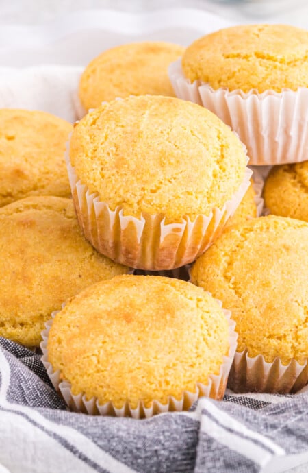 A close up of jiffy cornbread recipe muffins stacked on top of each other