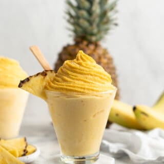 pineapple whip in a fancy glass with a pineapple garnish
