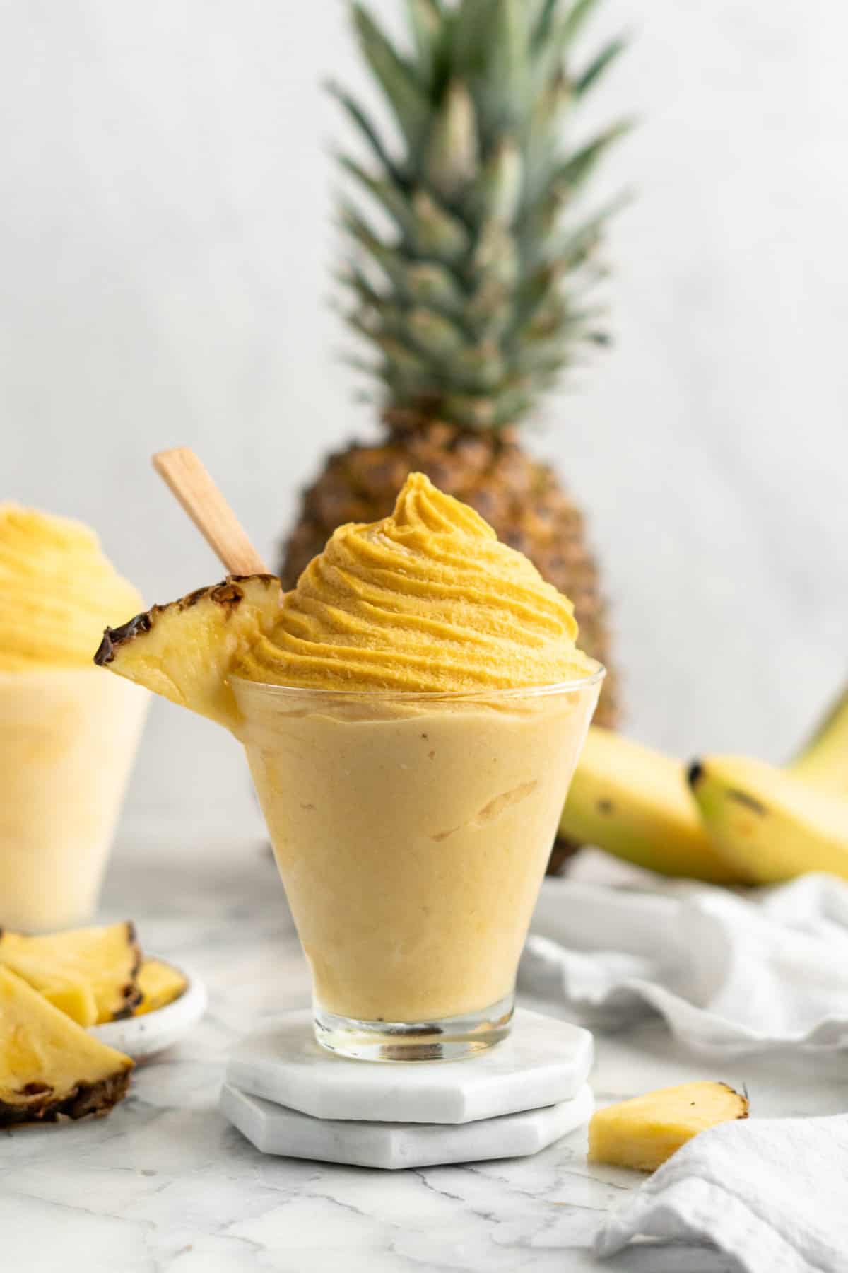 pineapple whip in a fancy glass with a pineapple garnish
