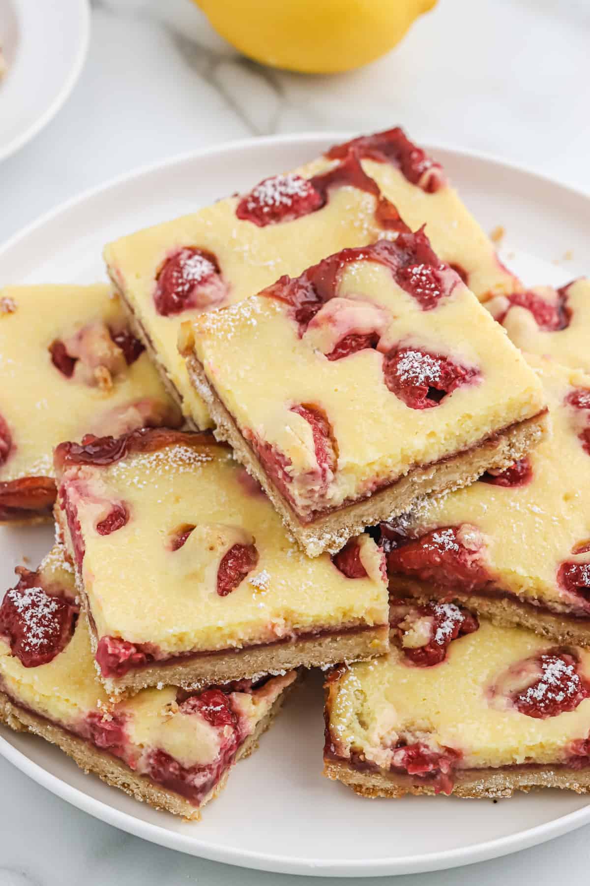 Raspberry lemon bars layered on a plate