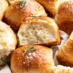 Side view of pull apart white cheddar rosemary dinner rolls.