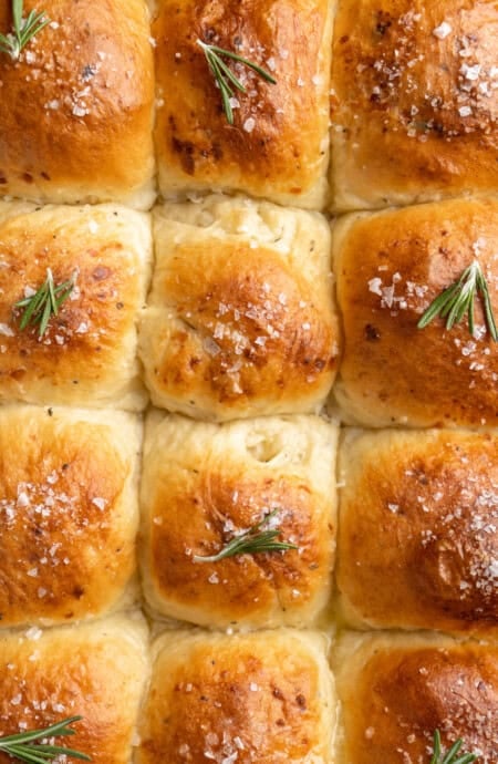 Closeup of white cheddar dinner rolls baked in a pan.