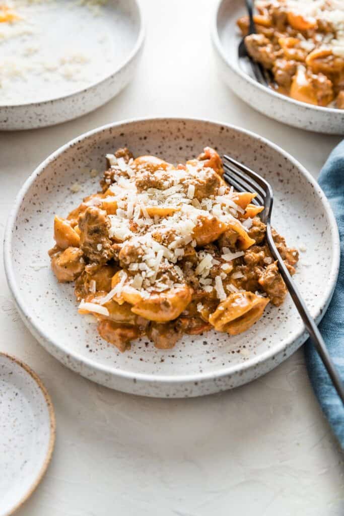cheesy hamburger helper on a plate with a fork