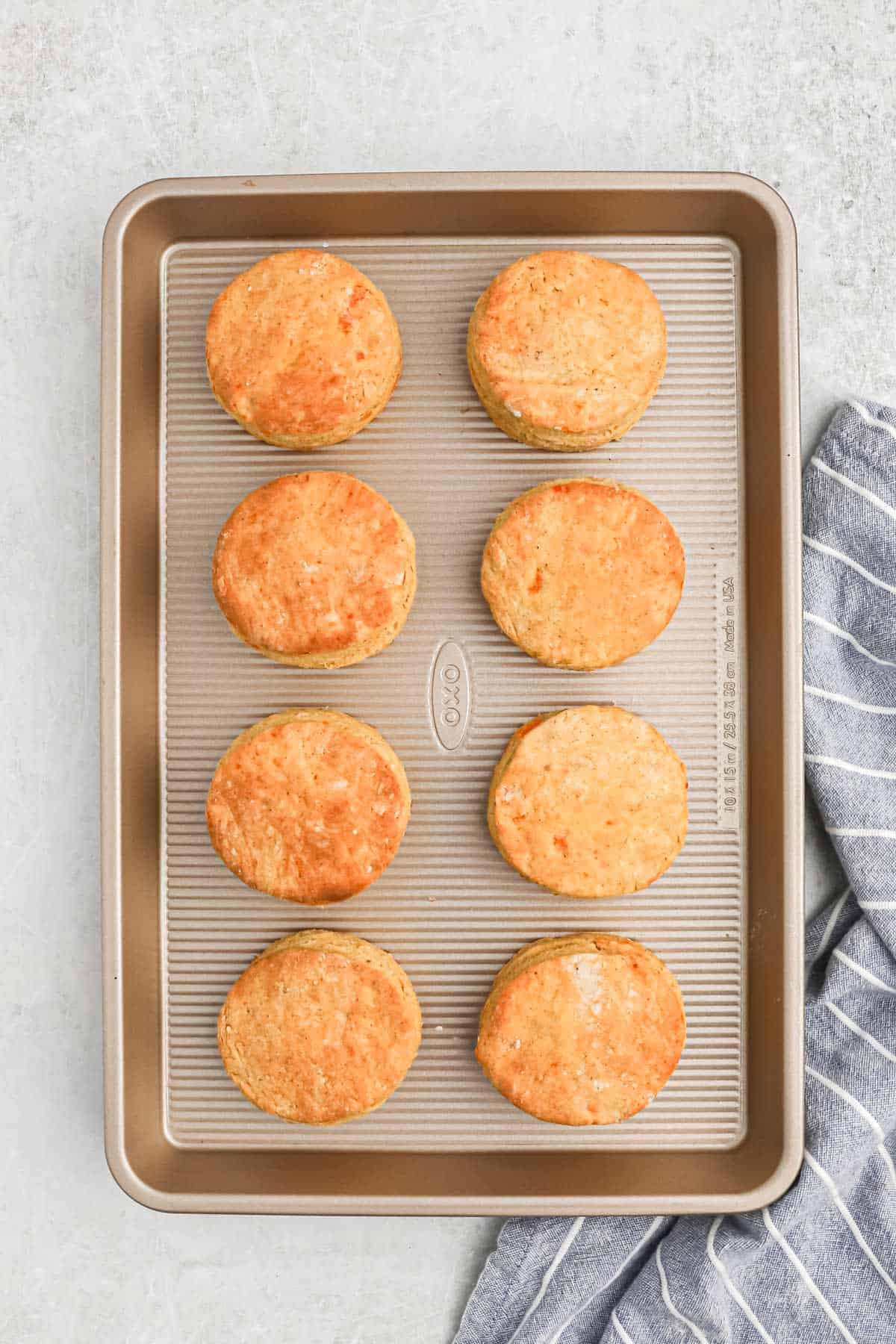 Cooked sweet potato biscuits on a baking tray.