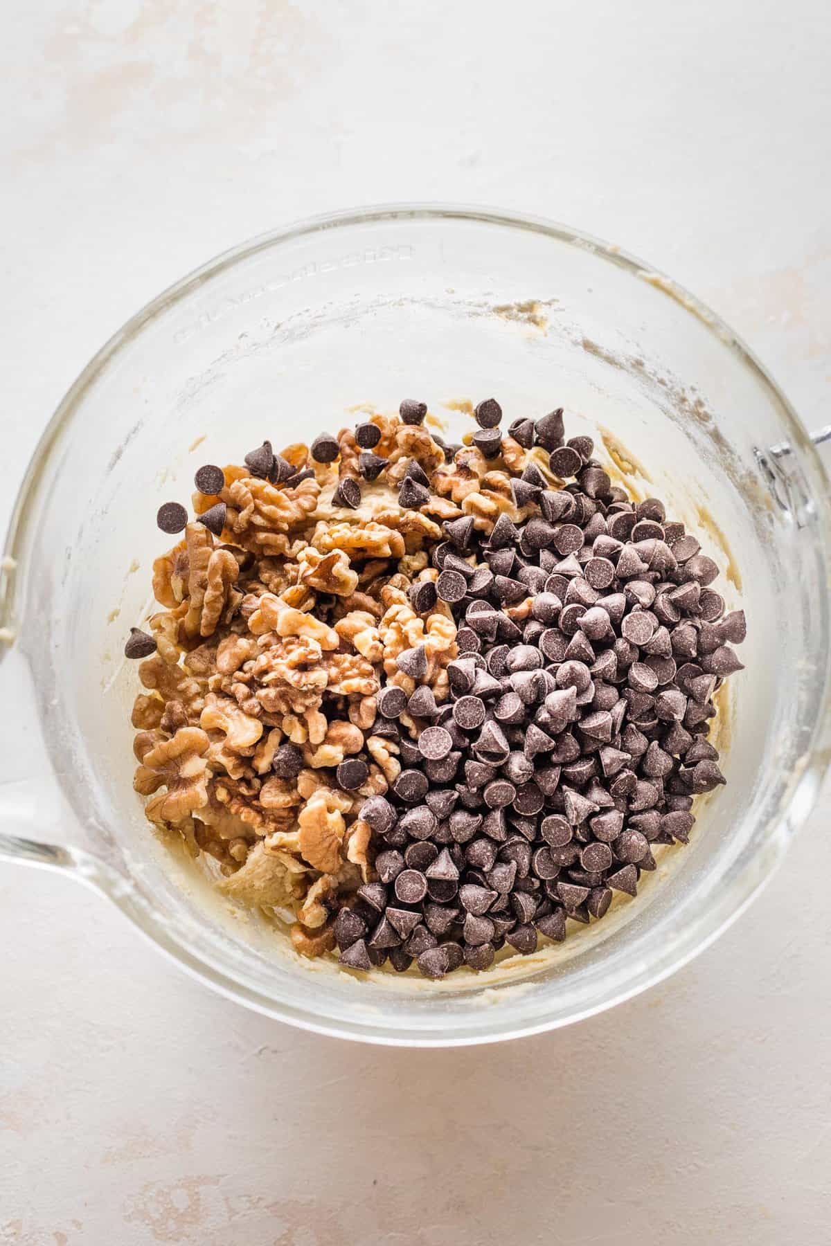 walnuts and chocolate chips added to the stand mixer bowl