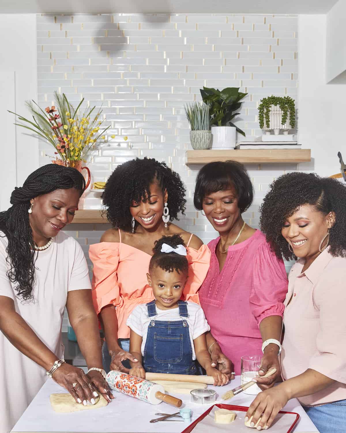 Family of Black women around a baking counter.