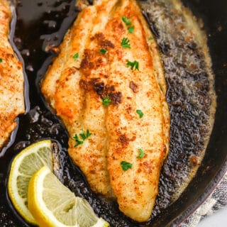Blackened catfish in a cast iron skillet.