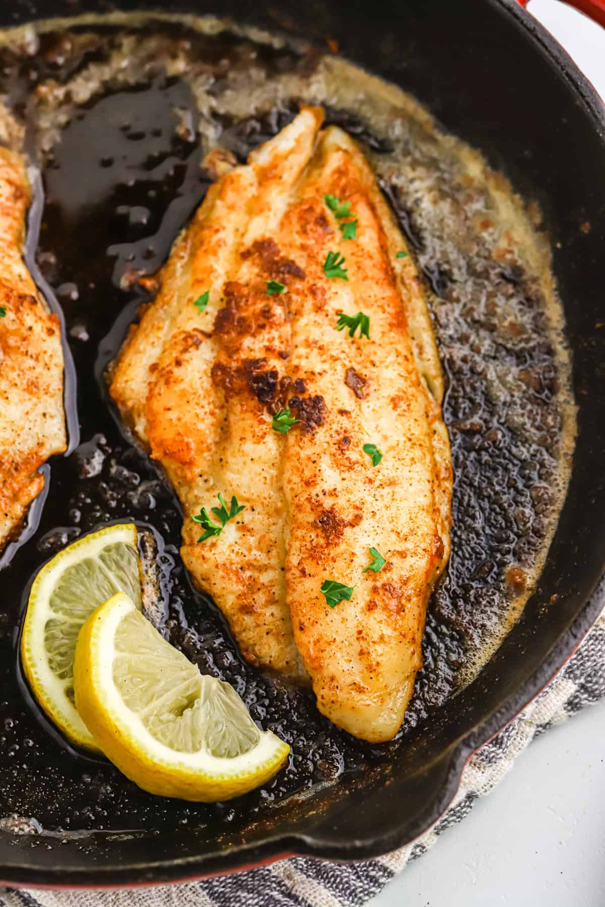 Blackened catfish in a cast iron skillet.