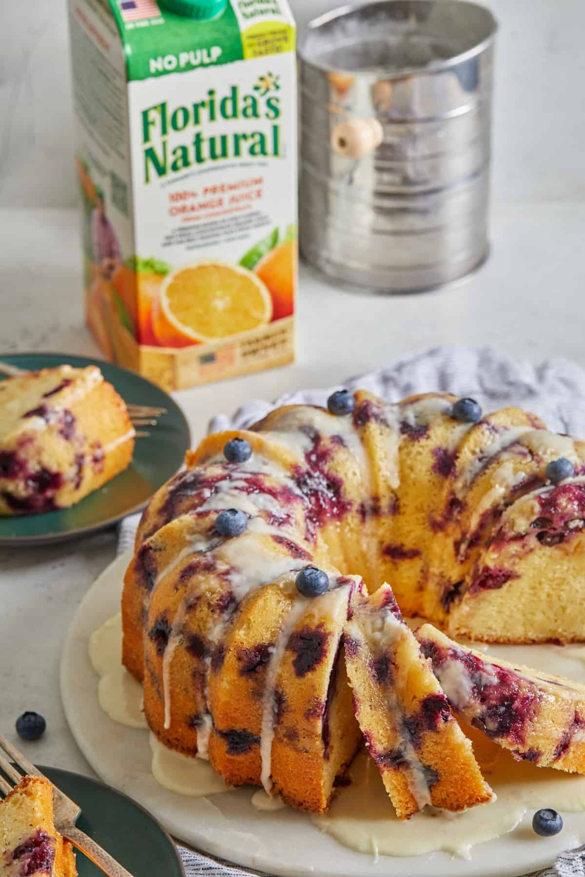 An orange blueberry bundt with slices cut ready to serve