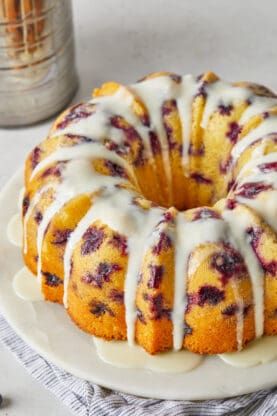 A delicious blueberry orange bundt cake with orange icing on top