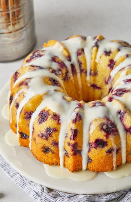 A delicious blueberry orange bundt cake with orange icing on top